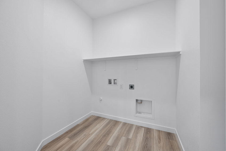 A white room with a wood floor.