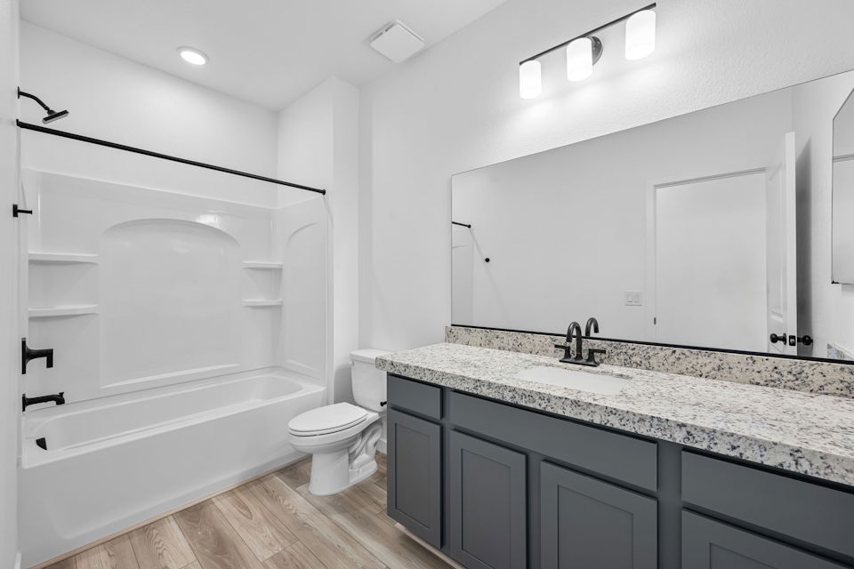 A bathroom with a large mirror.