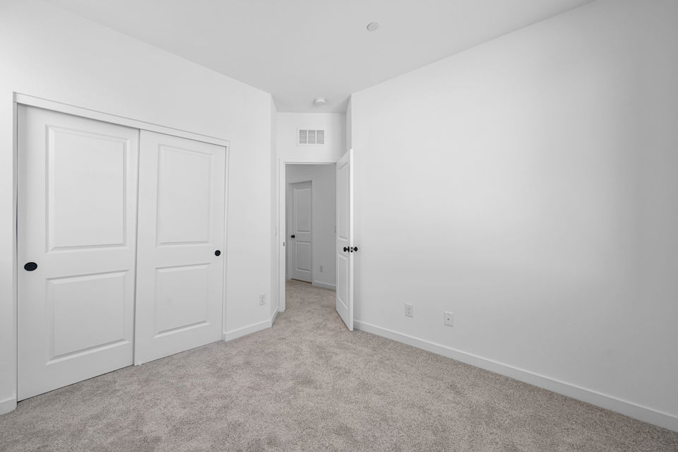 A hallway with white doors.