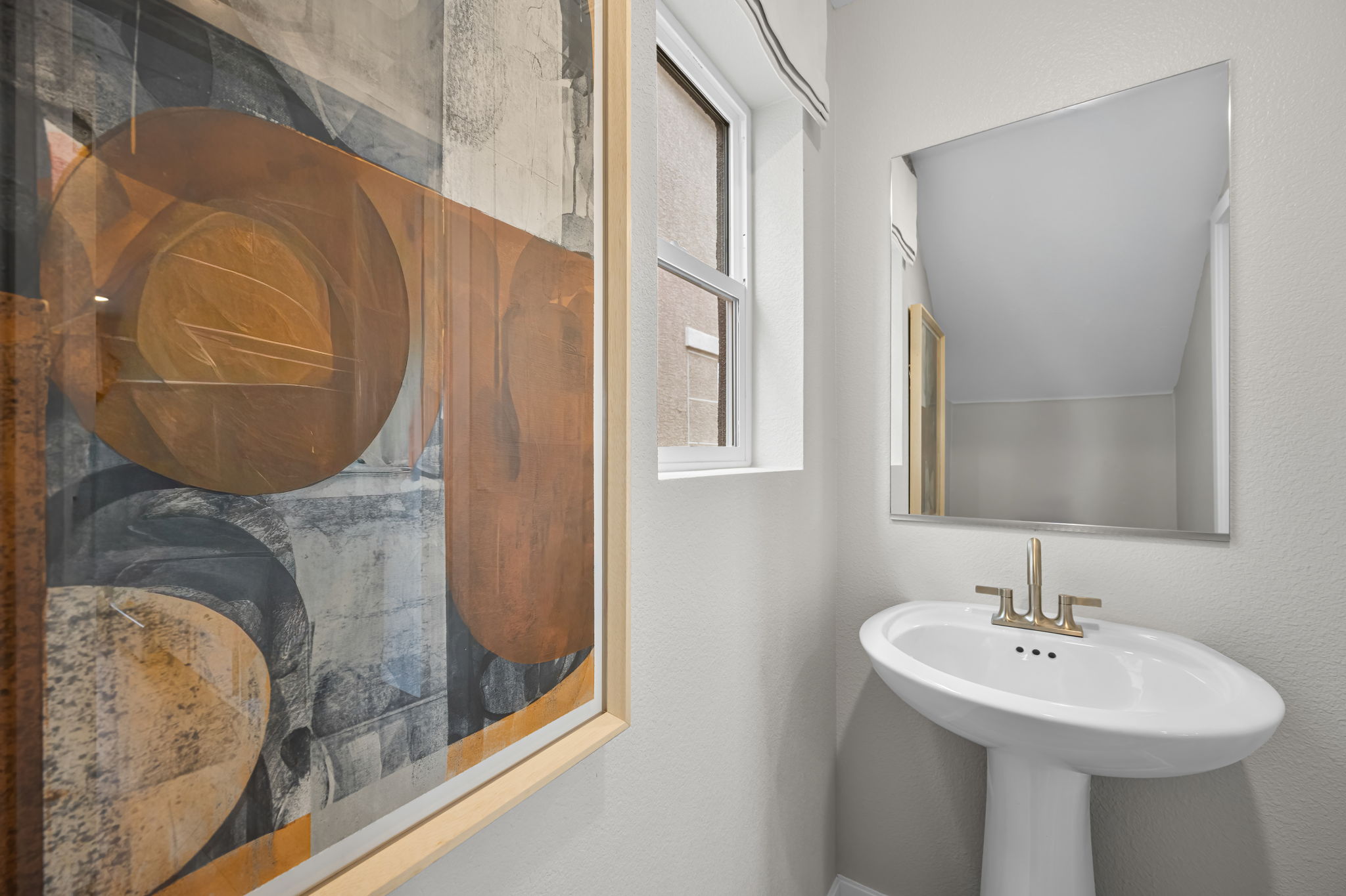 A bathroom with a large mirror.