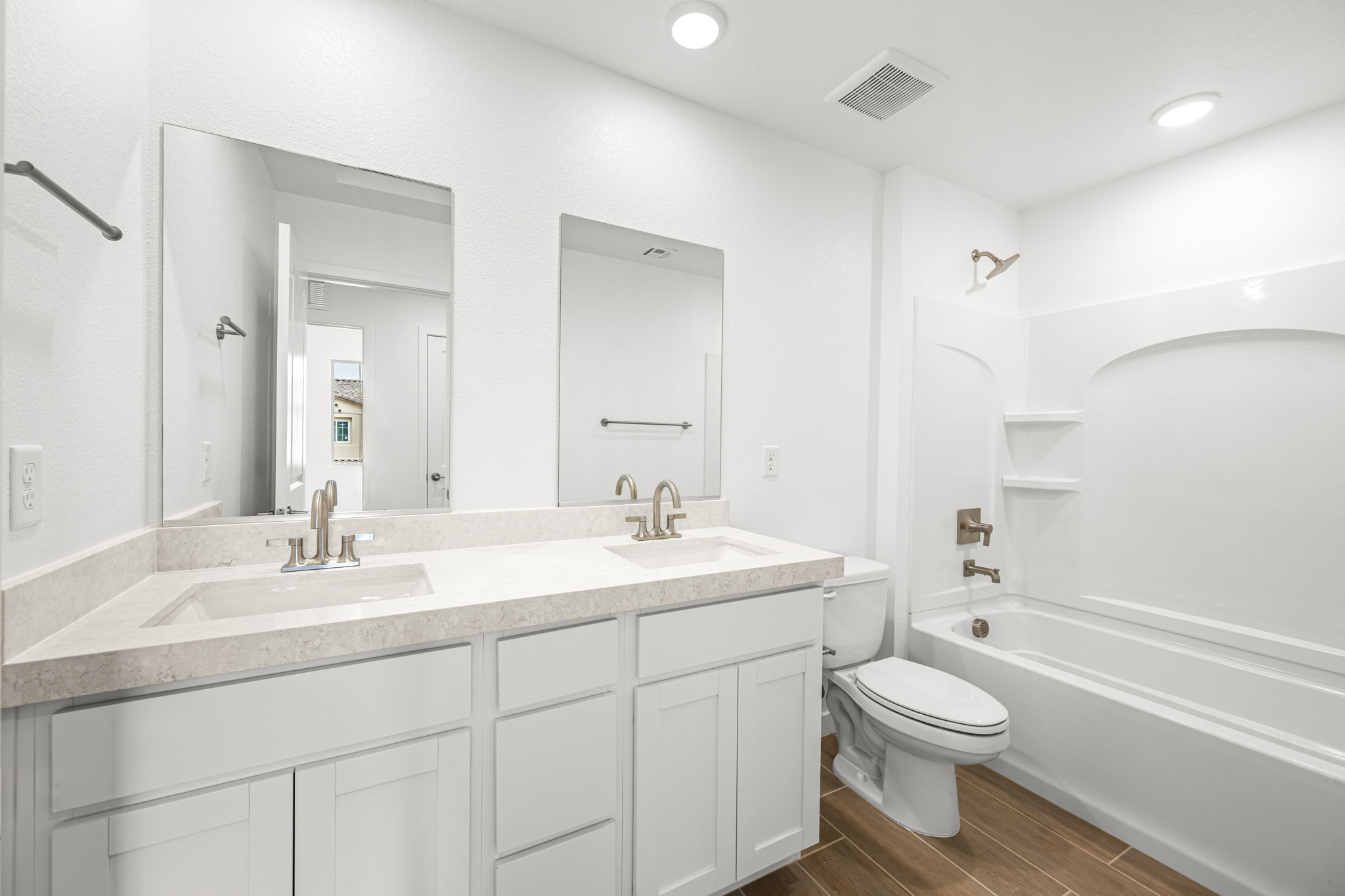 A bathroom with a tub sink and toilet.