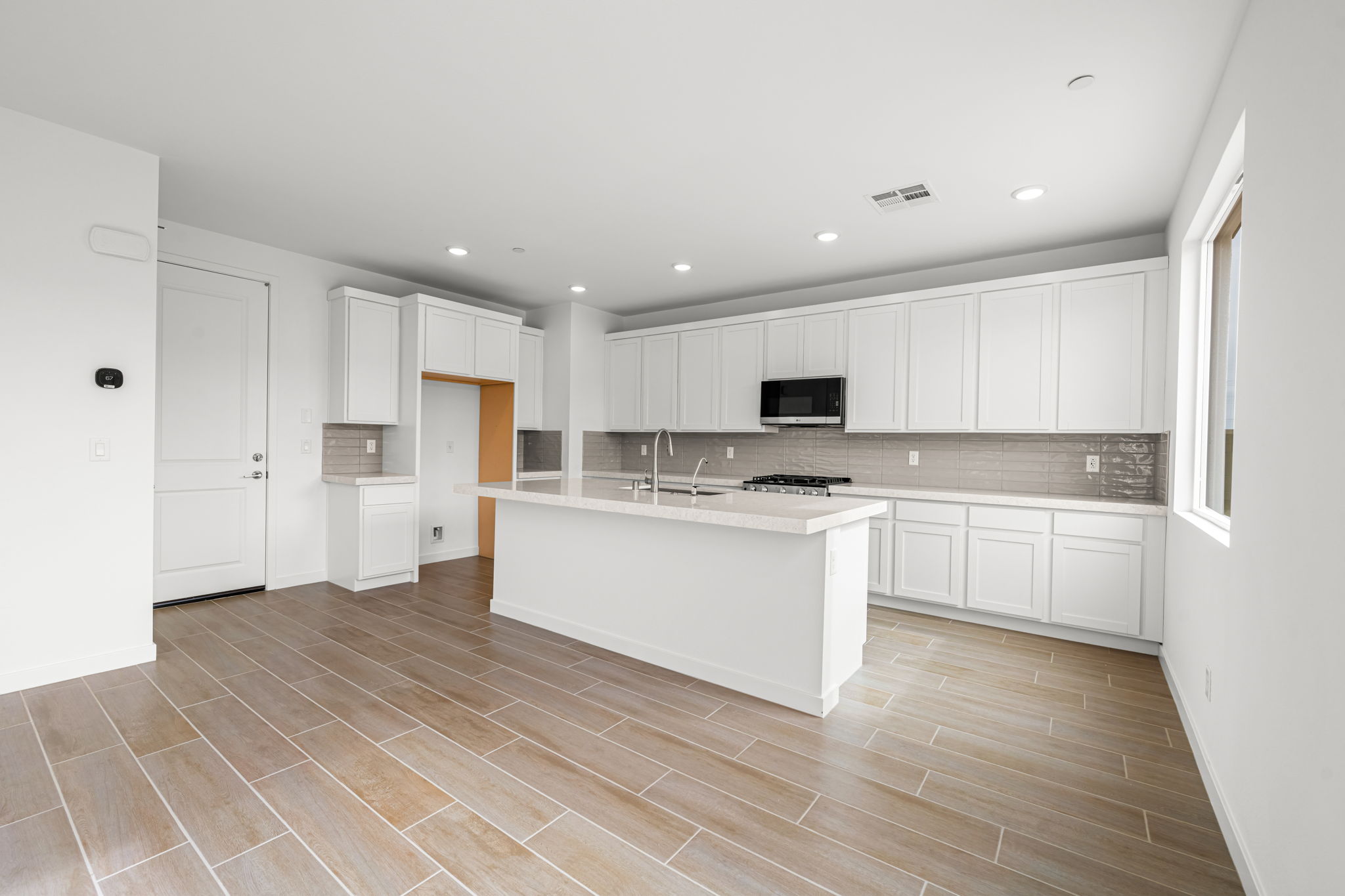 A kitchen with white cabinets.