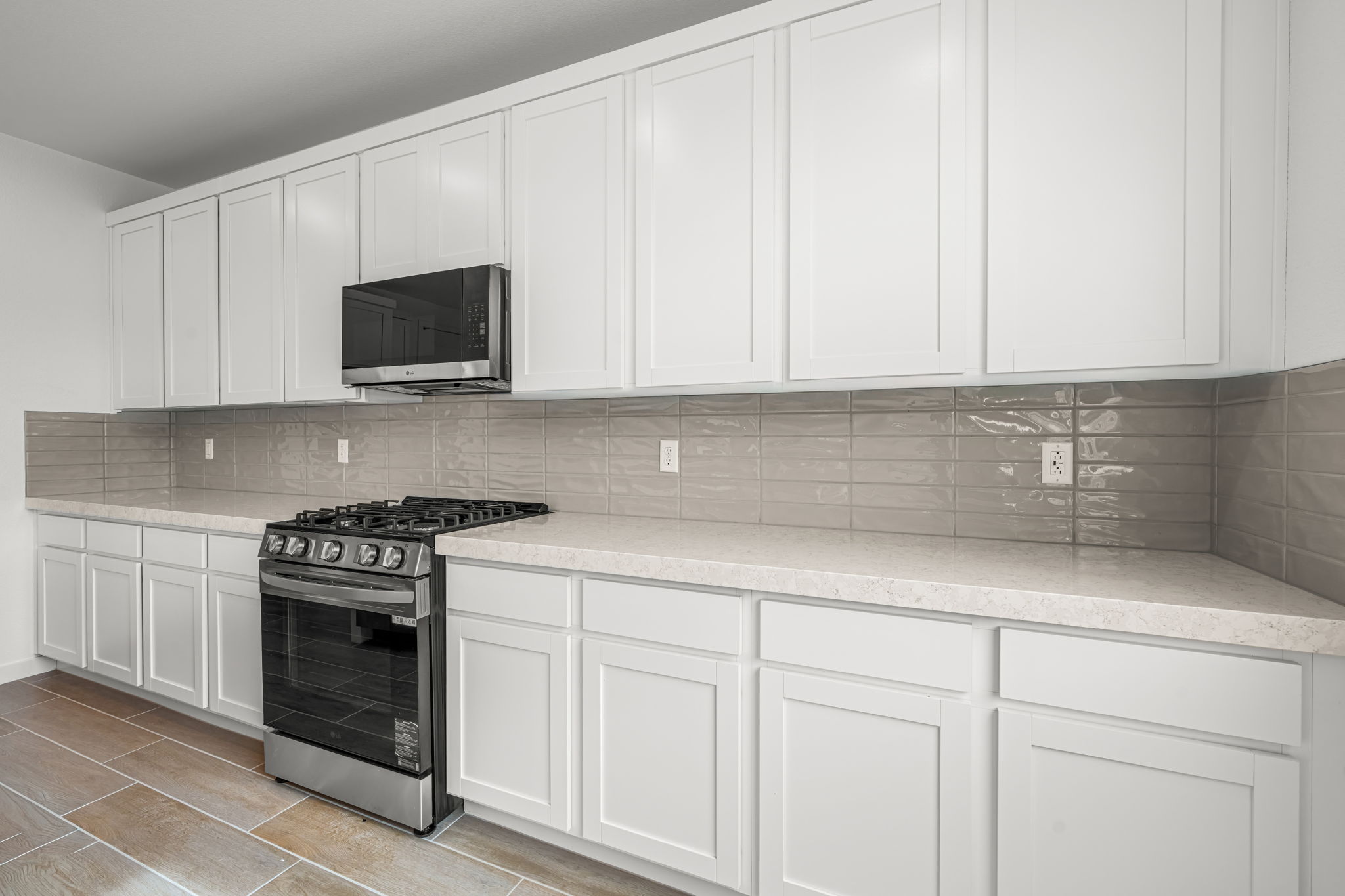 A kitchen with white cabinets.