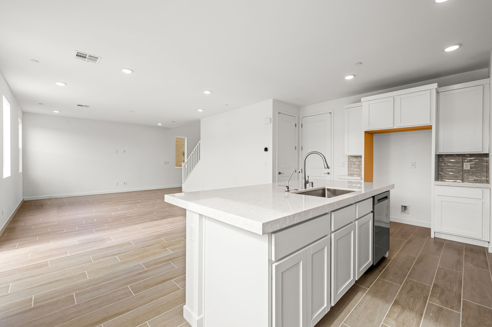 A kitchen with white cabinets.