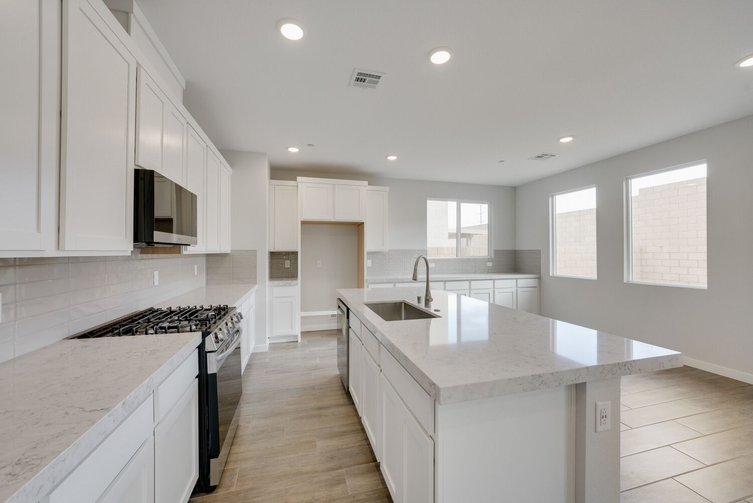 A kitchen with white cabinets.