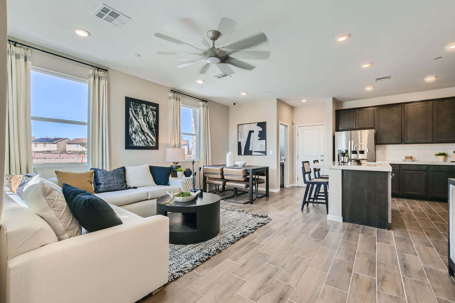 A living room with a large kitchen.