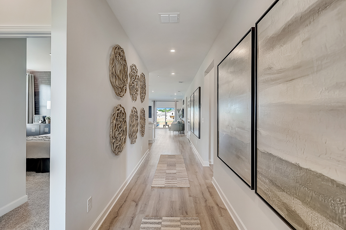 A hallway with a wood floor.