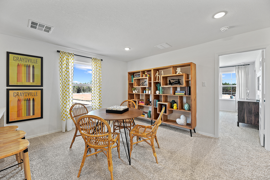 A room with a table and chairs.