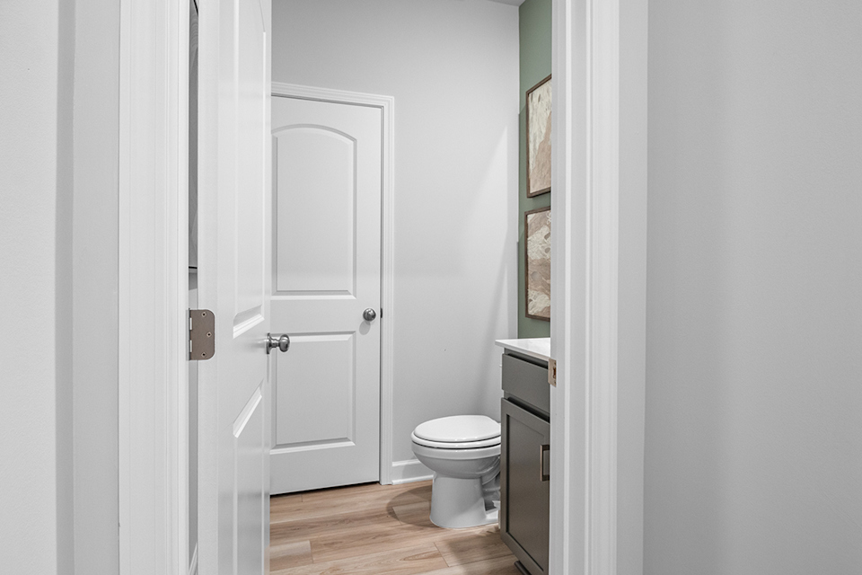 A bathroom with white doors.