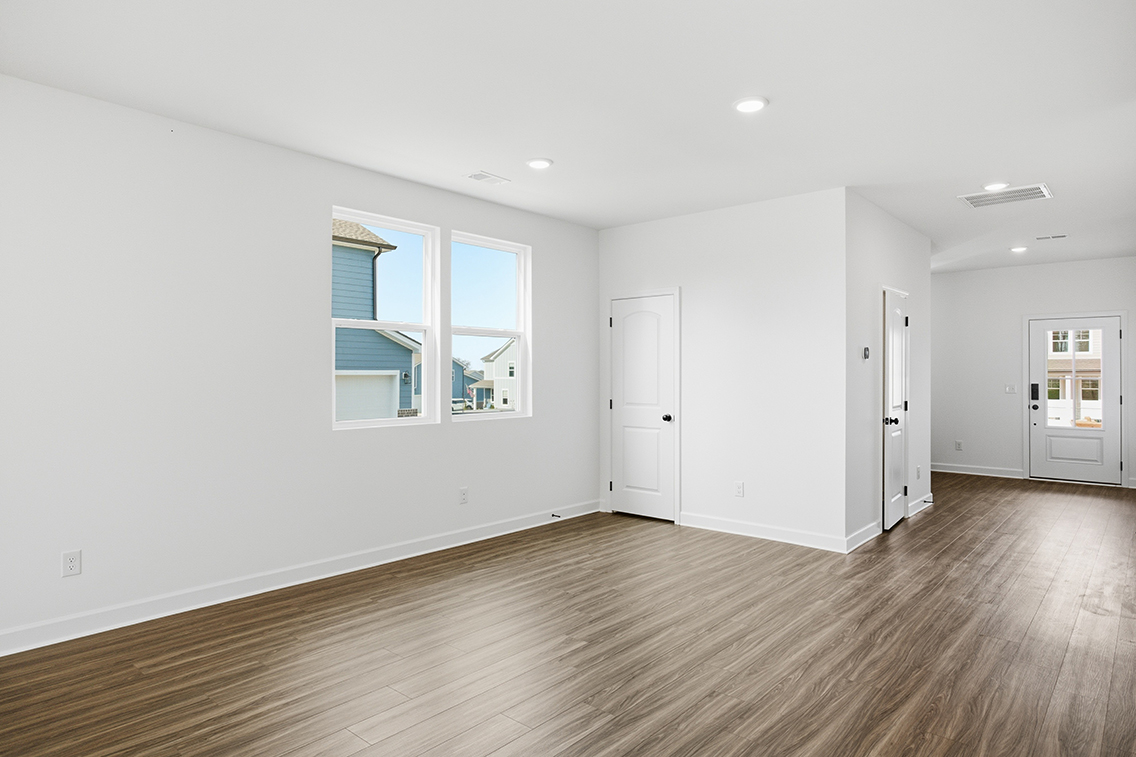 A room with white walls and a wood floor.