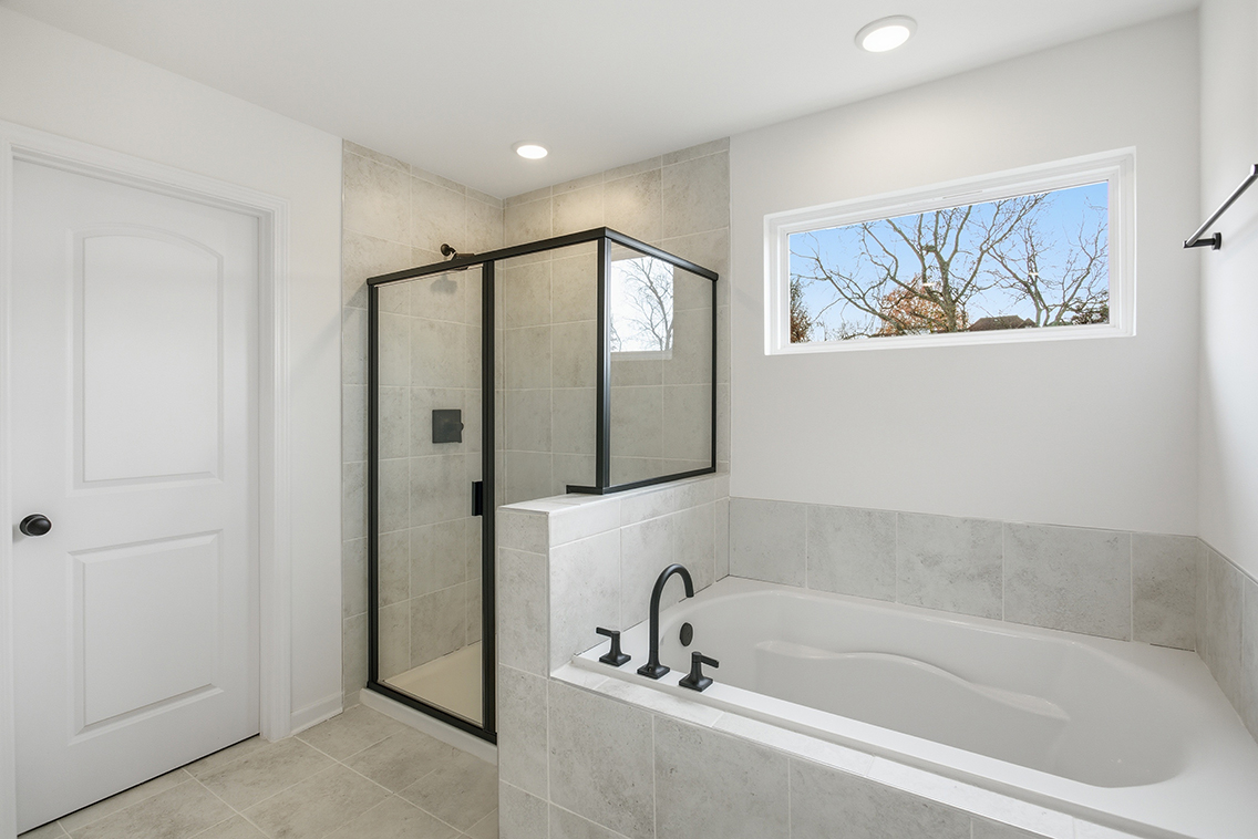 A bathroom with a tub and shower.