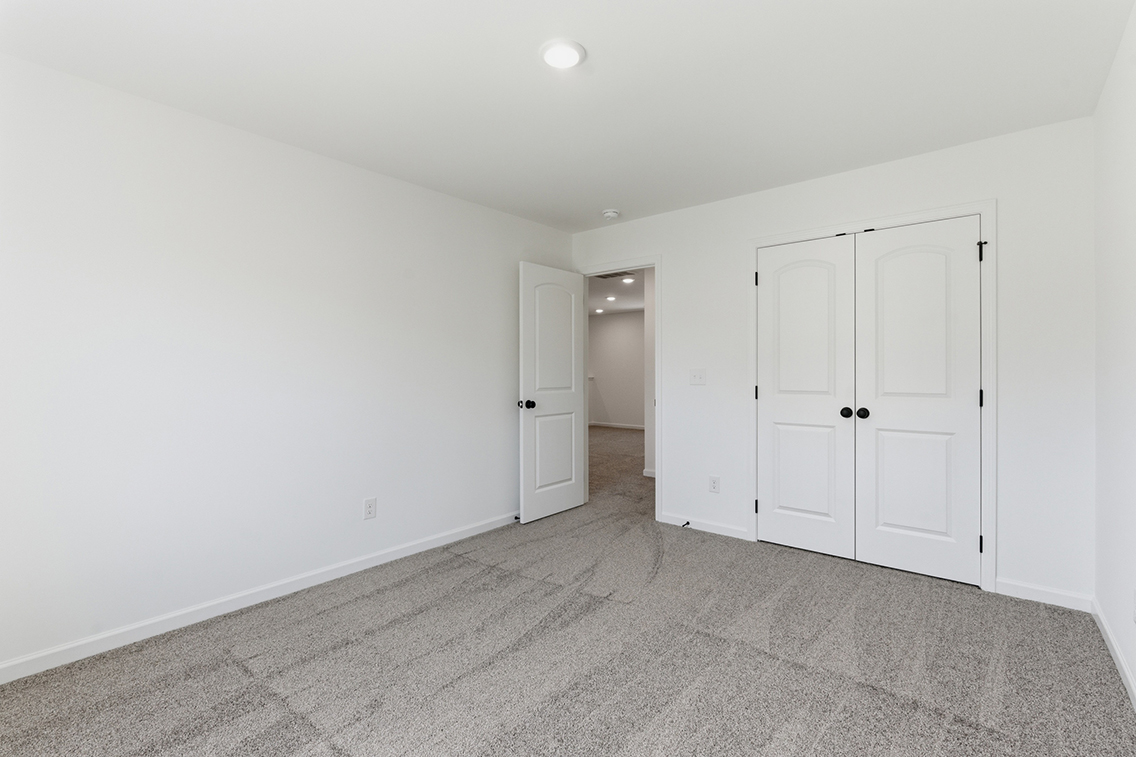 A hallway with white doors.