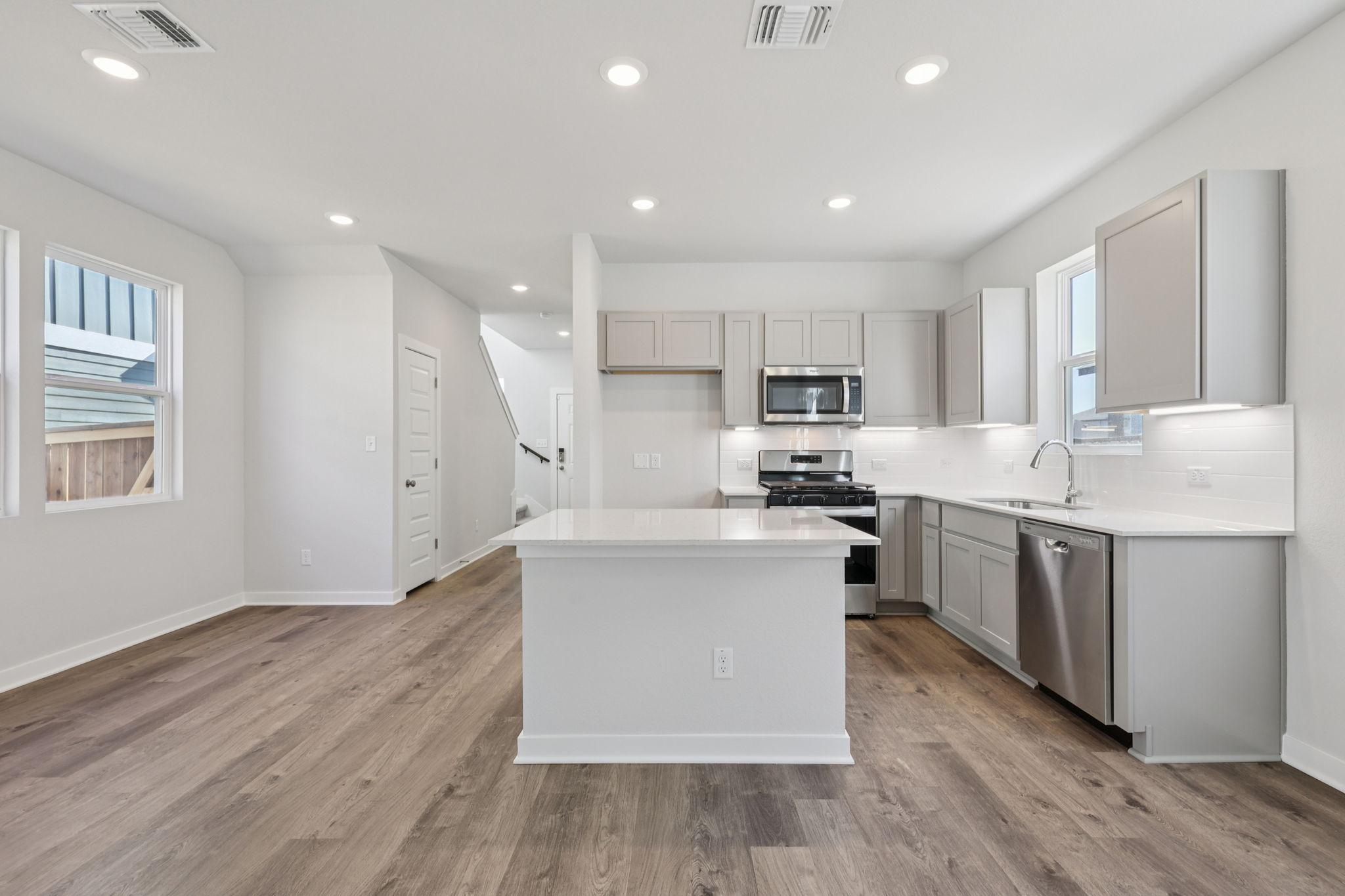A kitchen with white cabinets.