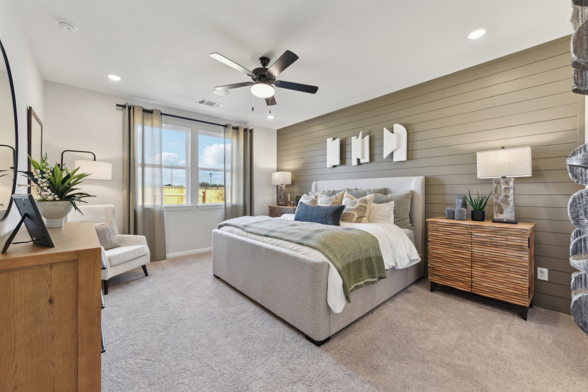 A bedroom with a bed and a fan.