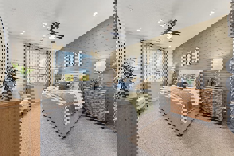 A bedroom with a bed and a fan.