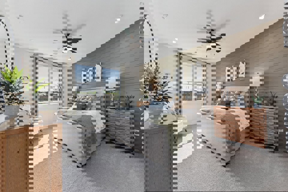 A bedroom with a bed and a fan.