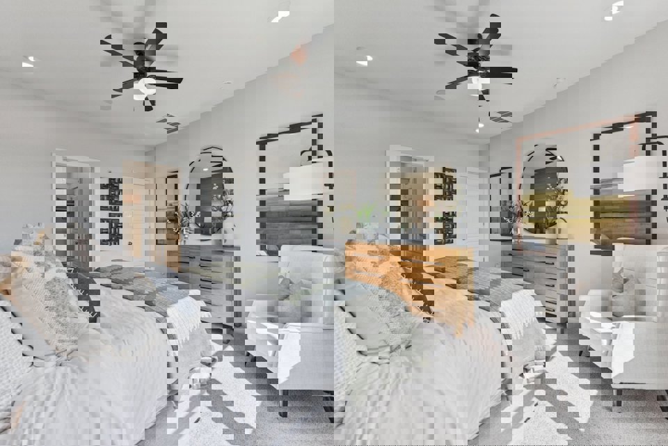 A bedroom with a bed and a fan.