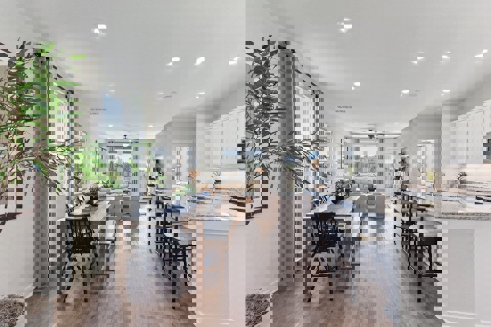 A kitchen with a dining table and chairs.