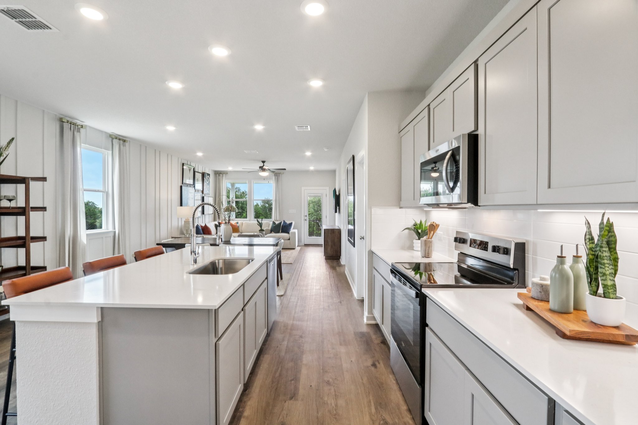 A kitchen with white cabinets.