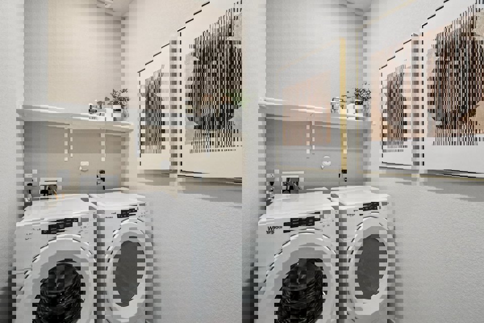 A washing machine and dryer in a room.
