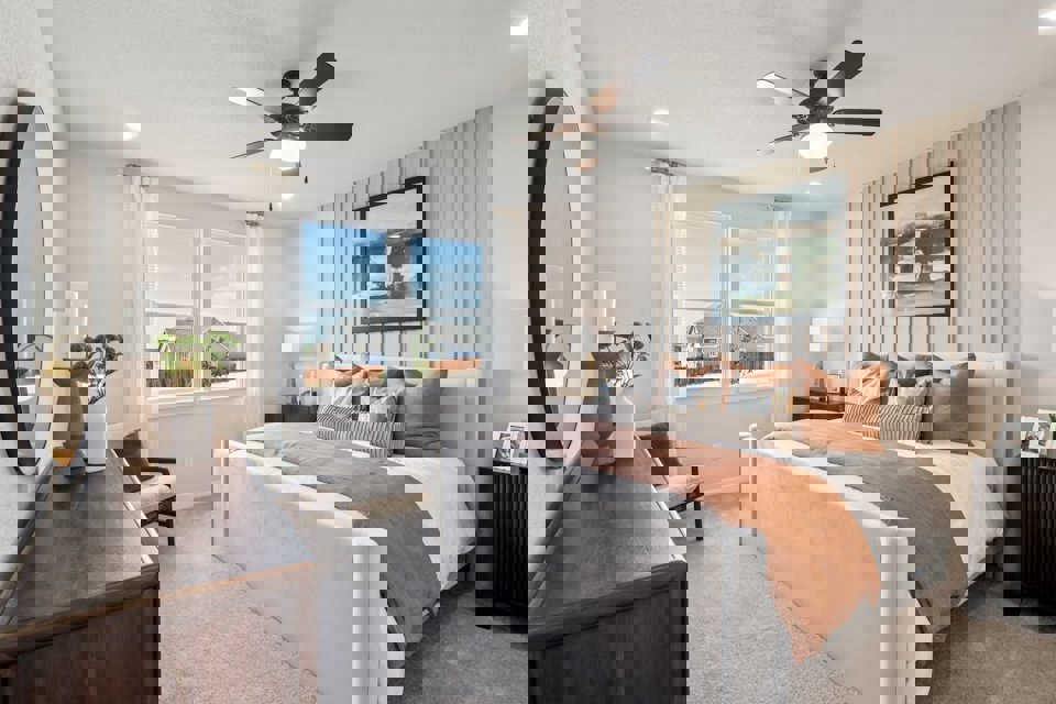 A bedroom with a large window.