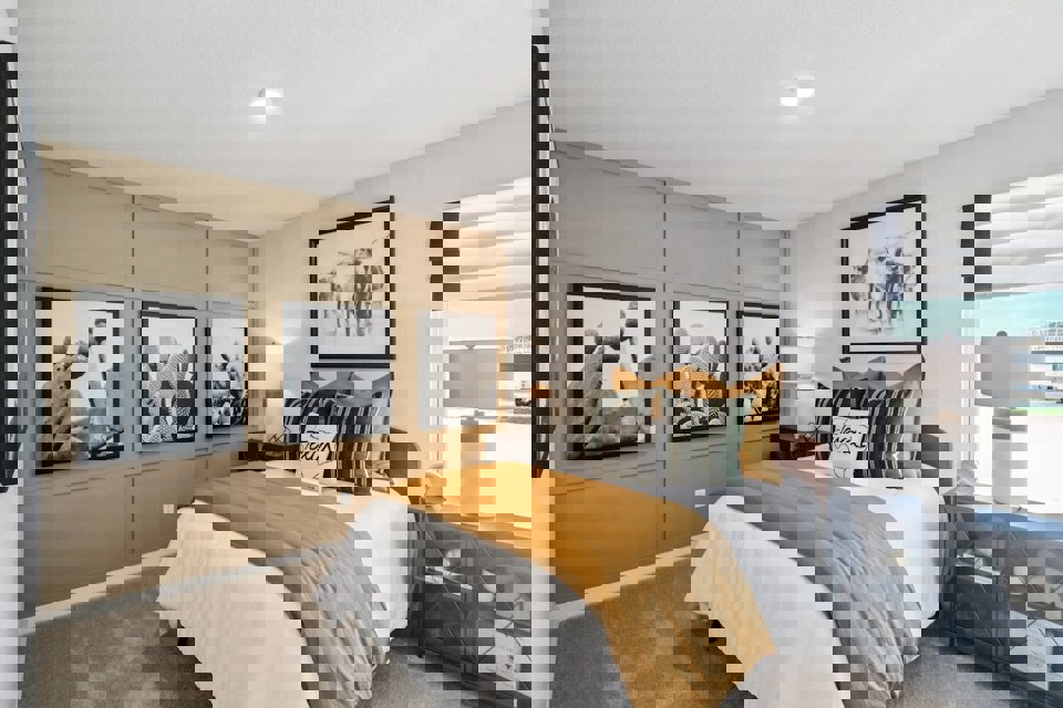 A bedroom with a bed and a window.