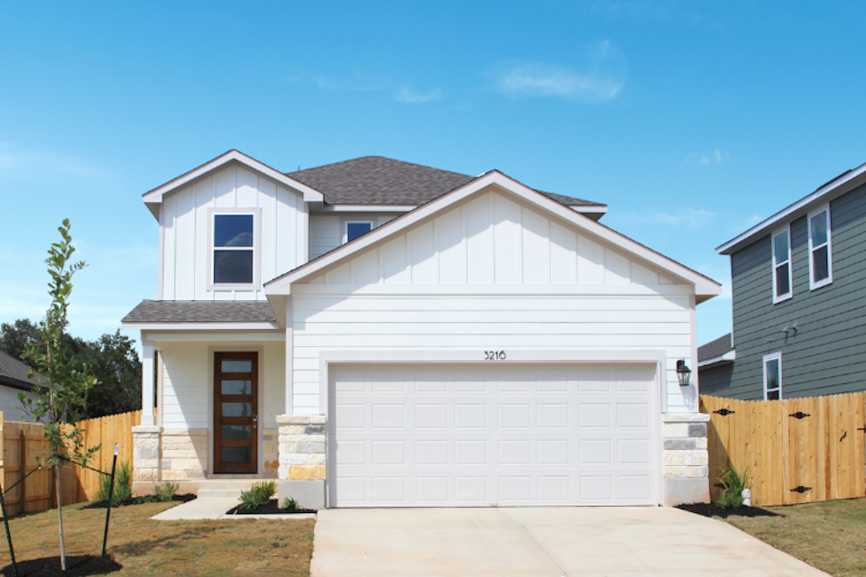 A white house with a fence.