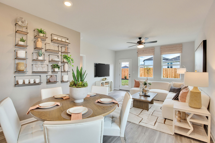A large living room with a large table and chairs.