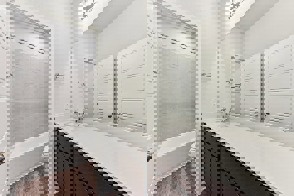 A bathroom with a tub and sink.