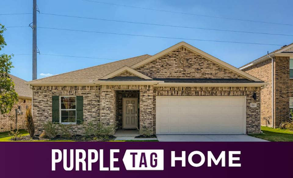 A brick house with a garage.