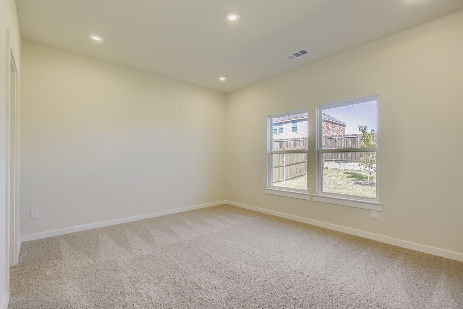 A room with a window and a door.