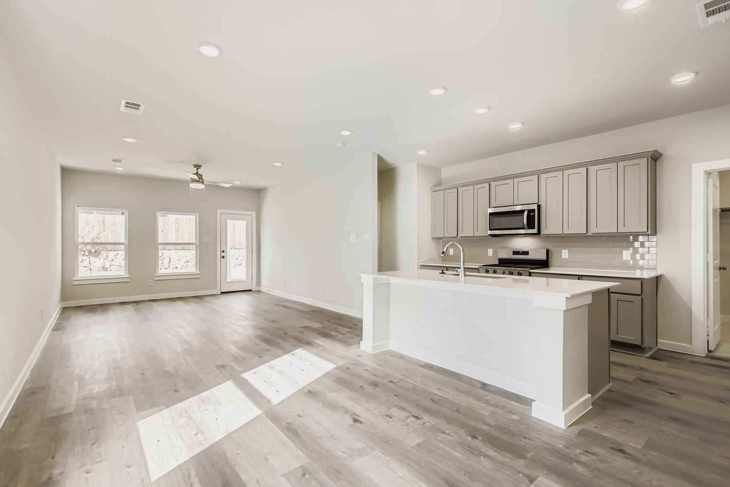 A kitchen with white cabinets.