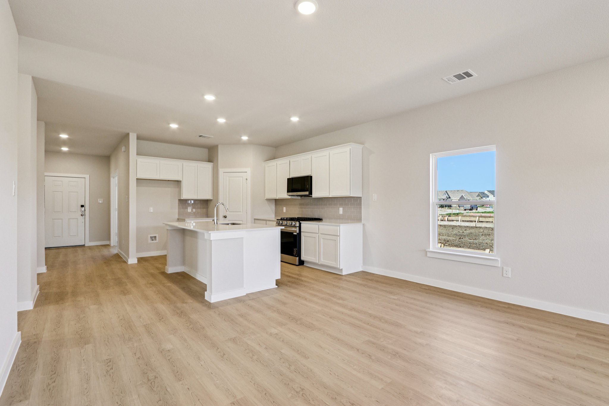 A kitchen with white cabinets.