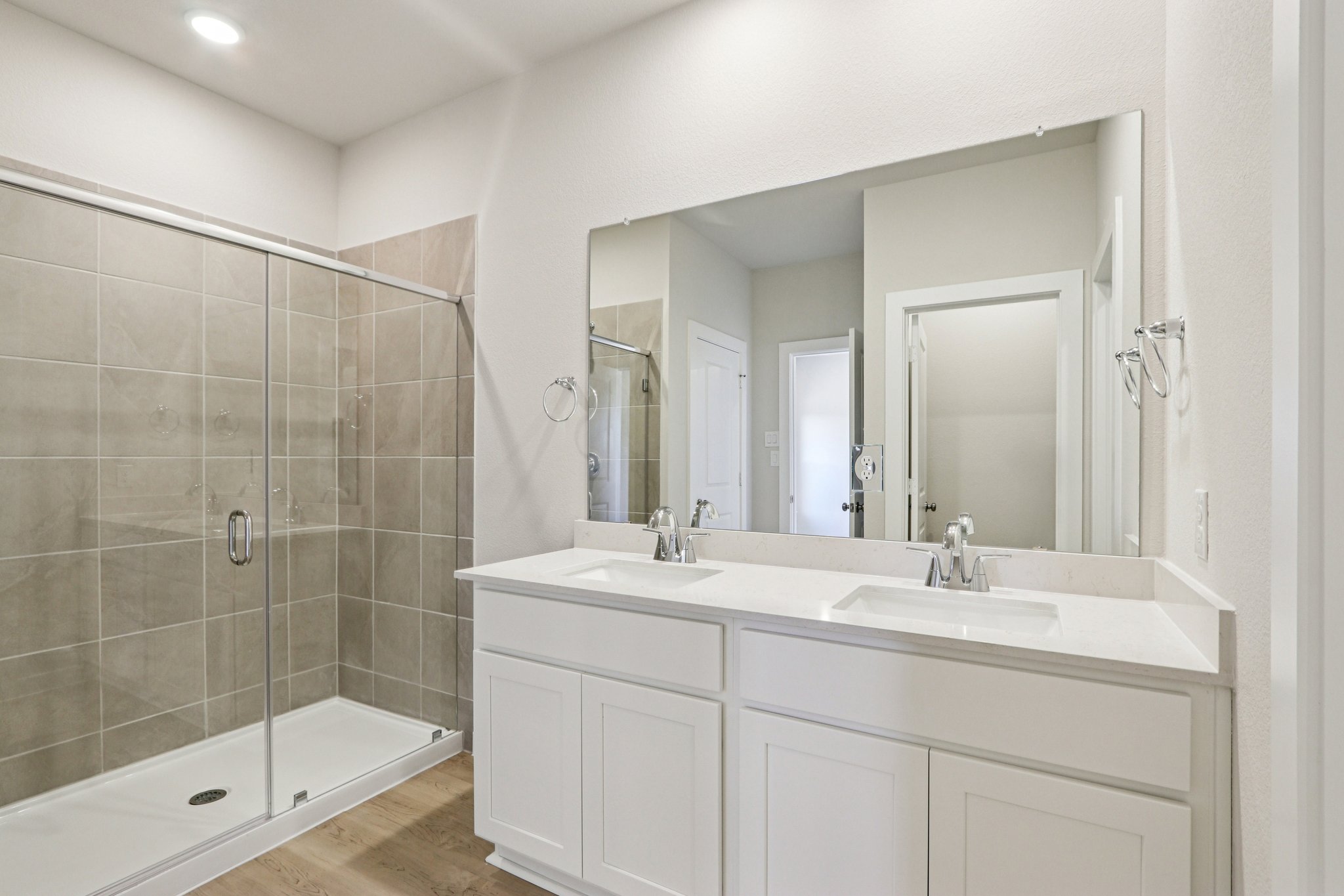 A bathroom with a large mirror.