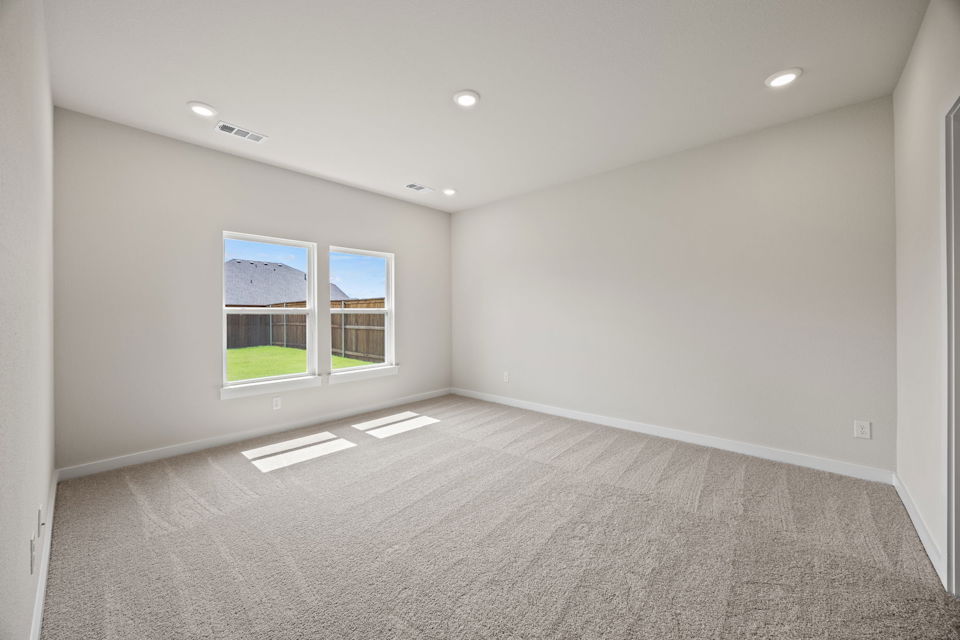 A room with a window and a carpet.