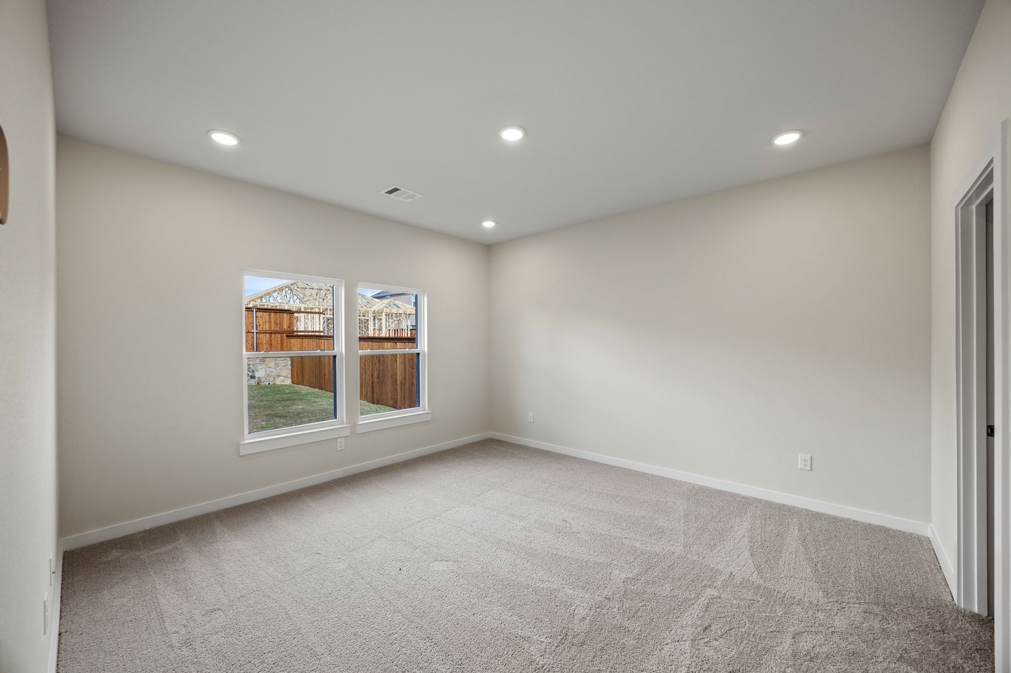 A room with a window and a carpet.