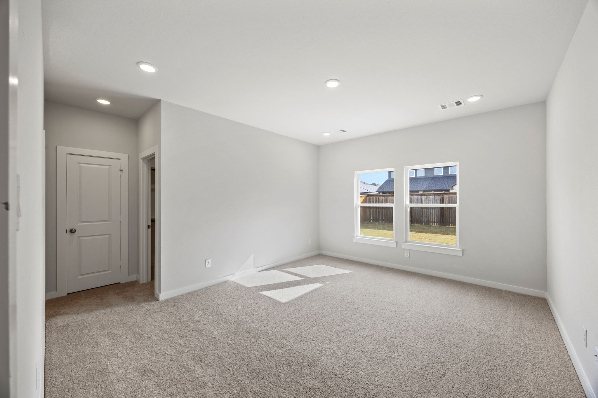 A room with white walls and a carpeted floor.