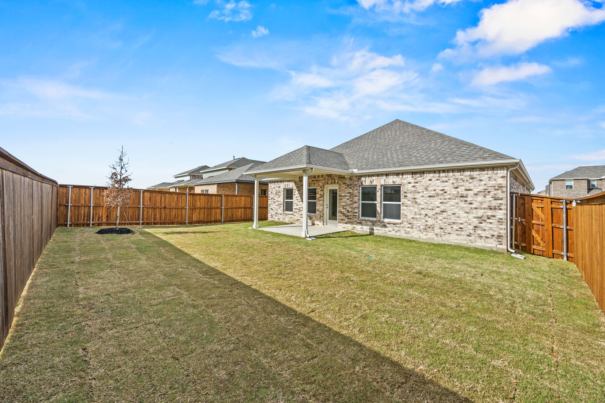 A house with a fence and grass.