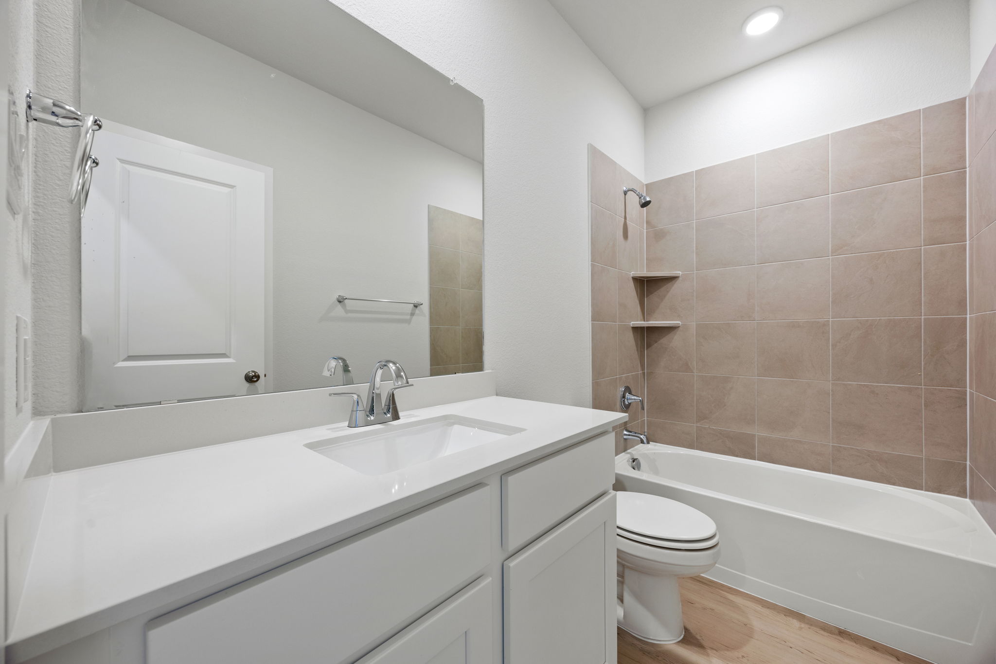 A bathroom with a tub sink and toilet.