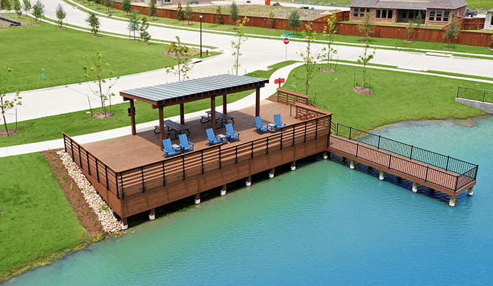 A pool with chairs and a deck.