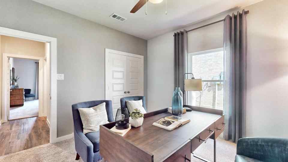 A living room with a table and chairs.