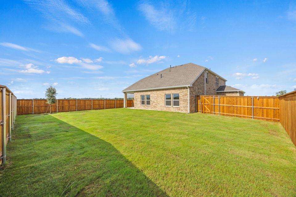 A house with a fence and grass.