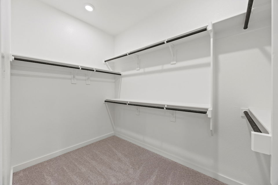 A white wall with a metal railing.