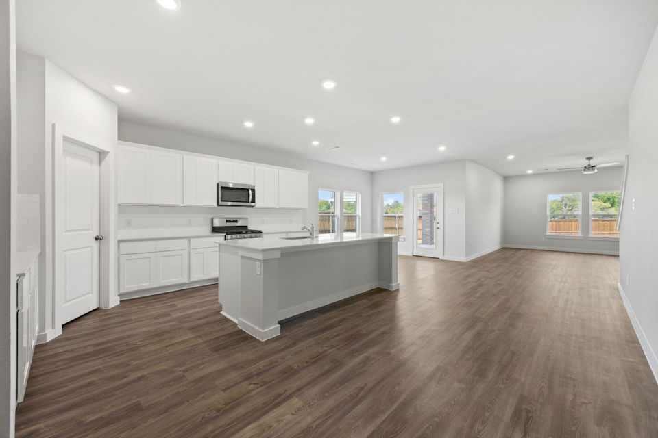A large kitchen with white cabinets.