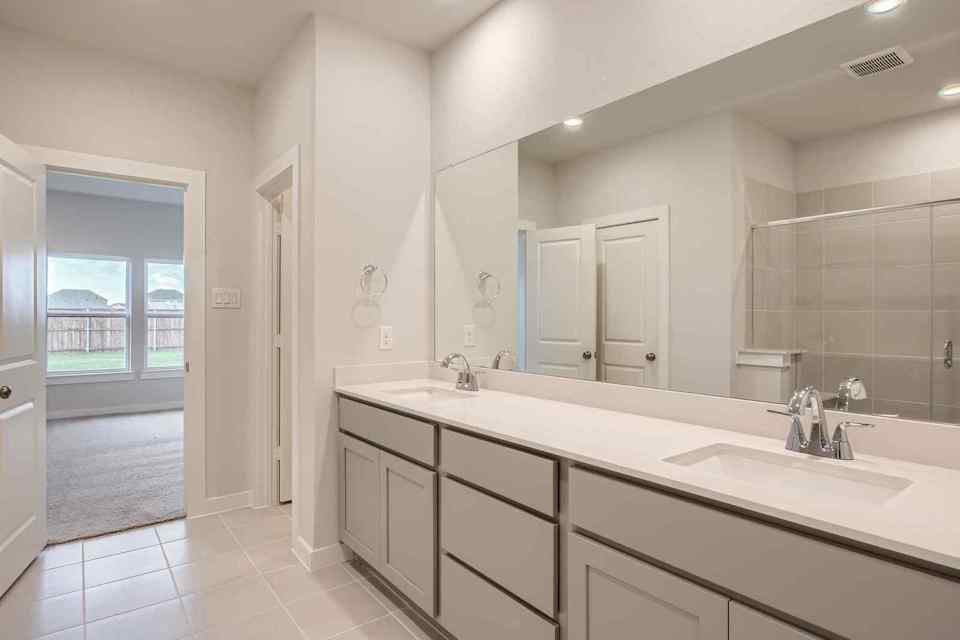 A bathroom with a large mirror.