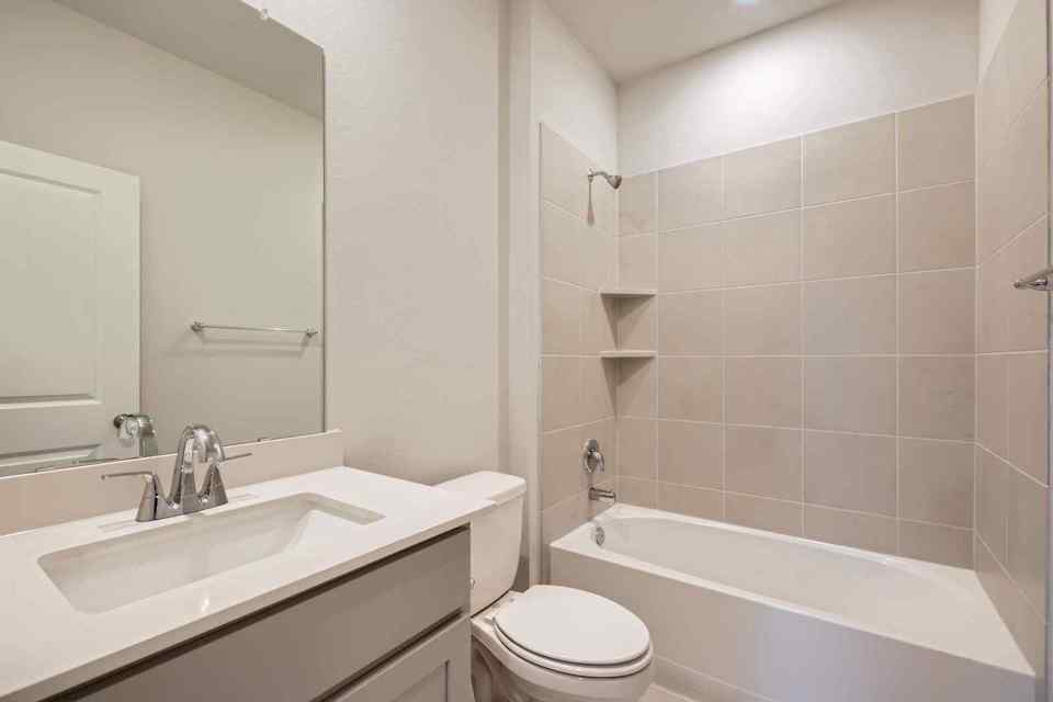 A bathroom with a tub sink and toilet.