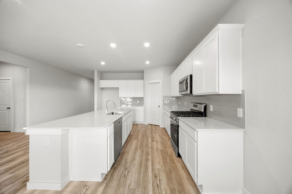 A kitchen with white cabinets.