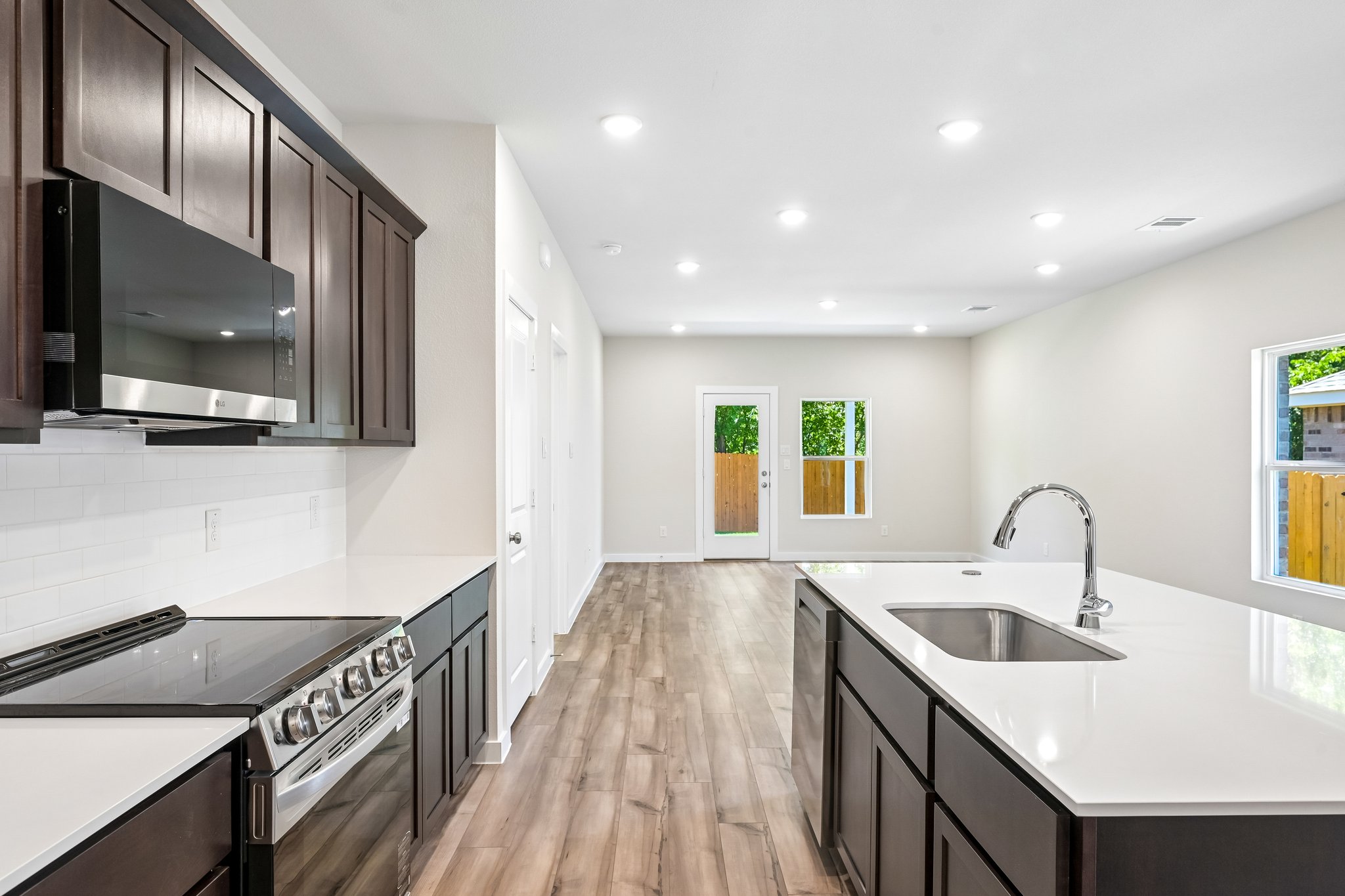 A kitchen with black cabinets.