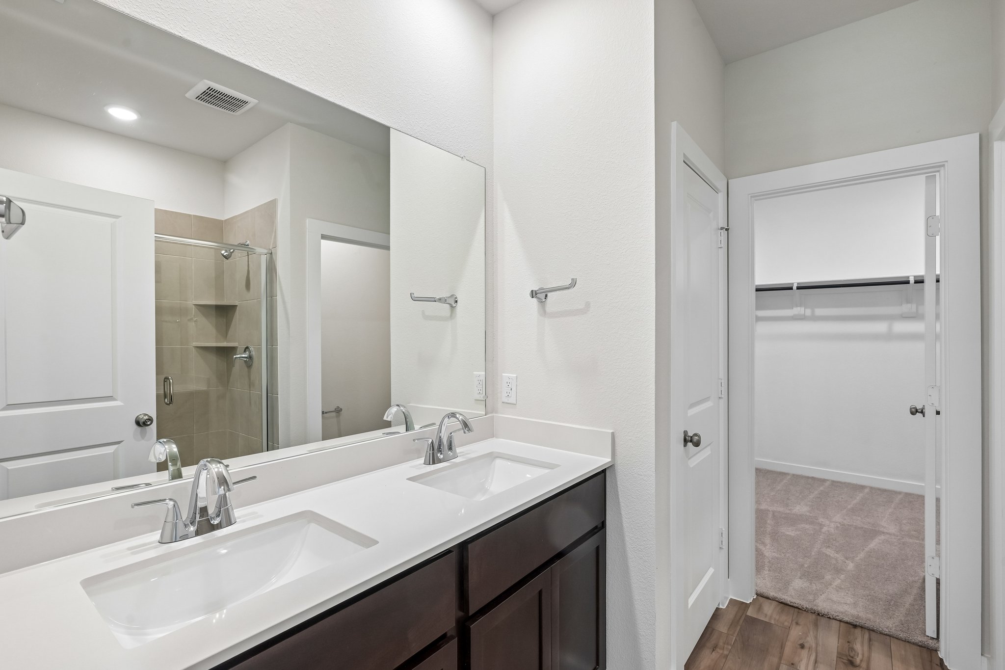 A bathroom with a large mirror.