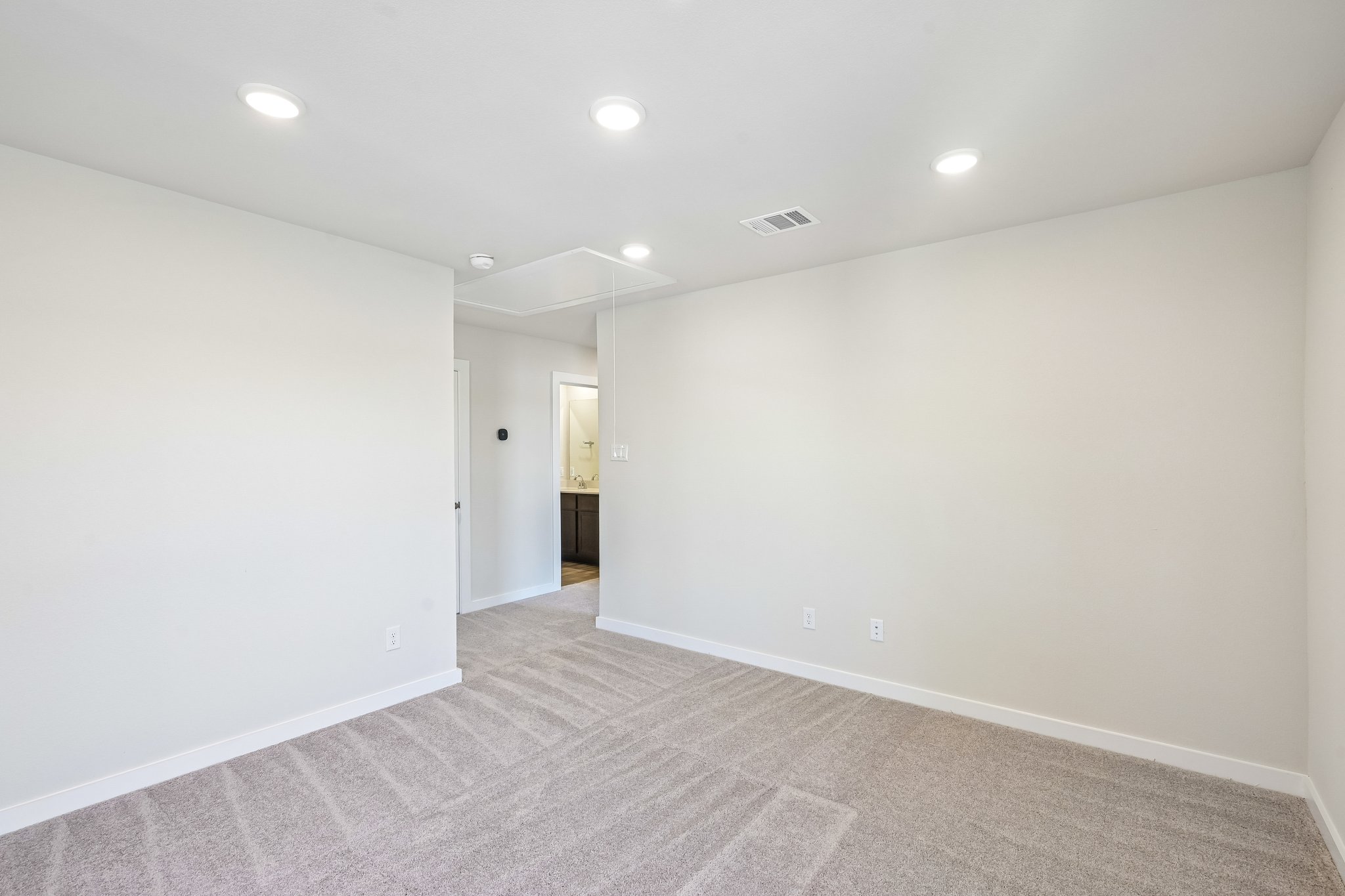 A hallway with white walls.